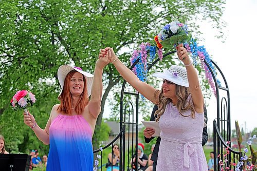 Wendy Friesen and Anastasia Jane Gibson hold hands for the first time as wives following their wedding at Rideau Park on Saturday. (Colin Slark/The Brandon Sun)