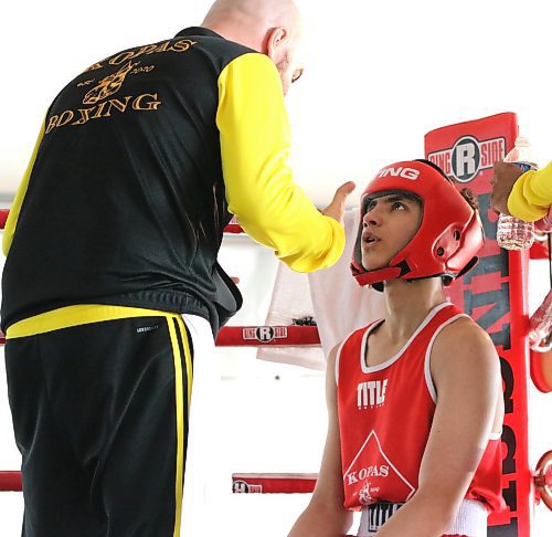 Ray (Sugar Ray) Abdo of Saskatoon listens carefully to Kopas Boxing coach Gary Kopas between rounds of his fight against Koby Chartrand during the Peak Boxing Event in a tent at the Riverbank Discovery Centre on Saturday evening. The five-hour show featured 25 bouts. Abdo emerged with a victory in three-round bout. (Perry Bergson/The Brandon Sun)