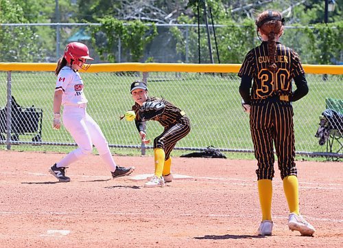 Westman Magic first baseman Brittyn DeVlieger (2) of Brandon reaches for the ball after a pickup attempt from the plate as Smitty's Terminators base runner Mia Wilcox (30) of Winnipeg) retreats to the bag safely during under-13 Manitoba Premier Softball League action at Ashley Neufeld Softball Complex on Sunday. (Perry Bergson/The Brandon Sun)
June 17, 2024