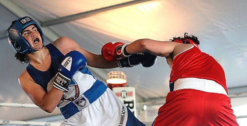 Bennett Cressman, in blue, ducks out of the way of a punch by Andy Lamirande of Pine Creek, in red, during the Peak Boxing Event in a tent at the Riverbank Discovery Centre on Saturday evening. Cressman won his fight. (Perry Bergson/The Brandon Sun)