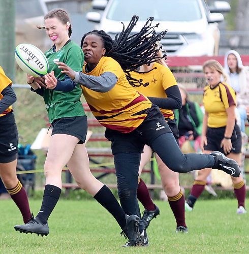 Dauphin Clippers ball carrier Ashley Korney has the ball knocked away from her from behind by Rebecca Alebiosu of Crocus Plains during the varsity girls rugby 7s provincial championship held at John Reilly Field. (Perry Bergson/The Brandon Sun)