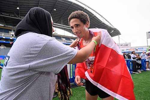 Mike Sudoma/Free Press
Runner Cam Levinsreceives a medal after his first place finish in the half marathon at the 46th annual Manitoba Marathon Sunday morning
June 15, 2024
