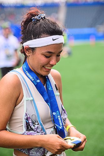 Mike Sudoma/Free Press
Fateman Jafari smiles while inspecting her medal she got from running her first full marathon at the 46th annual Manitoba Marathon Sunday morning
June 15, 2024
