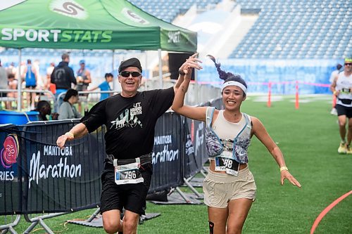 Mike Sudoma/Free Press
(Left to right) Jeff Staub of Lamp Lifeboat Ladder and Fateman Jafari cross the full marathon finish line at Sundays Manitoba Marathon
June 15, 2024
