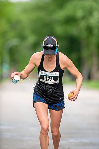 BROOK JONES / FREE PRESS
Winnipegger Dawn Neil cools off at a fluids station as she runs down Wellington Crescent on her way to winning the women's full marathon, which was the 46th running of the Manitoba Marathon in Winnipeg, Man., Sunday, June 16, 2024.