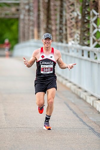 BROOK JONES / FREE PRESS
Winnipeg resident John Coffin shows his enthusiasm as he crosses the BDI bridge as he competes in Half Marathon National Championships at the Manitoba Marathon in Winnipeg, Man., Sunday, June 16, 2024.