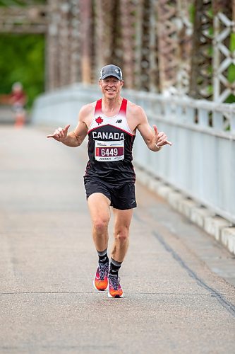 BROOK JONES / FREE PRESS
Winnipeg resident John Coffin shows his enthusiasm while he crosses the BDI bridge as he competes in Half Marathon National Championships at the Manitoba Marathon in Winnipeg, Man., Sunday, June 16, 2024.