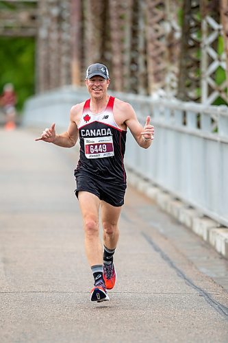 BROOK JONES / FREE PRESS
Winnipeg resident John Coffin shows his enthusiasm while he crosses the BDI bridge as he competes in Half Marathon National Championships at the Manitoba Marathon in Winnipeg, Man., Sunday, June 16, 2024.