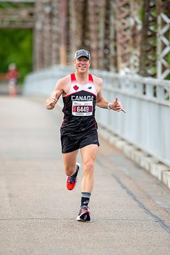 BROOK JONES / FREE PRESS
Winnipeg resident John Coffin shows his enthusiasm while he crosses the BDI bridge as he competes in Half Marathon National Championships at the Manitoba Marathon in Winnipeg, Man., Sunday, June 16, 2024.