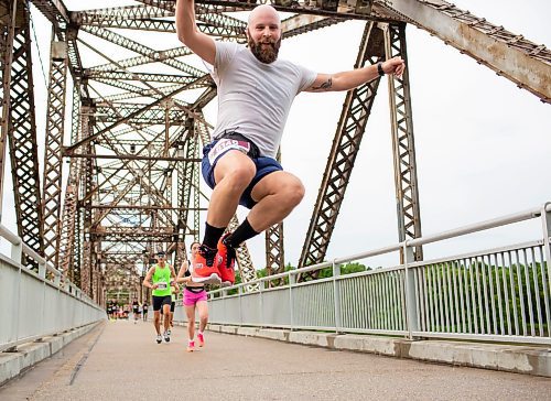 BROOK JONES / FREE PRESS
Dave Gagnon leaps in the air as he crosses the BDI bridge in the half marathon race at the 46th annual Manitoba Marathon in Winnipeg, Man., Sunday, June 16, 2024.