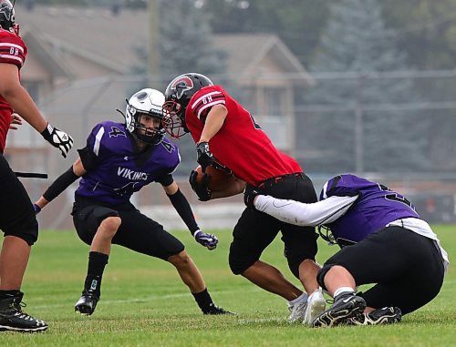 Vincent Massey's Zach Redekop, left, lines up a Sisler ball carrier while Vikings teammate Scott Sherb brings him down during football season in the fall. (Thomas Friesen/The Brandon Sun)