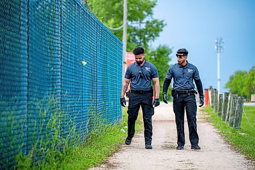 NIC ADAM / FREE PRESS
Following an incident at the Red River Ex over the weekend, security along its perimeter is increasing. 
Toro Security guards, Gurtaj Singh (left) and Manpreet Singh, check the perimeter of the RRE on Monday afternoon. They say that it&#x2019;s here along the fence, between the service and main entrances, that they find the most contraband; at least one or two items every time they pass by. 
240617 - Monday, June 17, 2024.

Reporter: Chris
