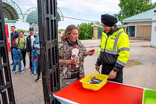 NIC ADAM / FREE PRESS
Following an incident at the Red River Ex over the weekend, security along its perimeter is increasing. 
Toro Security guard, Akashdeep Singh, checks carnival goers bags and items as they enter the fair grounds on Monday afternoon.
240617 - Monday, June 17, 2024.

Reporter: Chris
