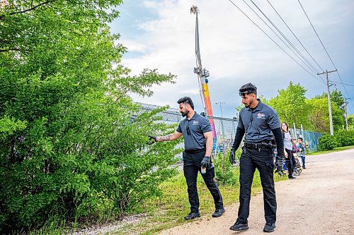 NIC ADAM / FREE PRESS
Following an incident at the Red River Ex over the weekend, security along its perimeter is increasing. 
Toro Security guards, Gurtaj Singh (left) and Manpreet Singh, check the perimeter of the RRE on Monday afternoon. They say that it&#x2019;s here along the fence, between the service and main entrances, that they find the most contraband; at least one or two items every time they pass by. 
240617 - Monday, June 17, 2024.

Reporter: Chris
