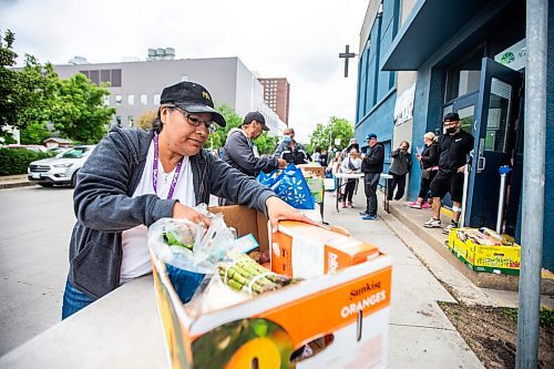 MIKAELA MACKENZIE / FREE PRESS

Joanne Nimik packs up her food bank box at Agape Table on Furby Street on Tuesday, June 18, 2024. The organization is currently experiencing an unprecedented increase in requests for food assistance, and is putting out the call for more donations to support the need.

For Jura story.

