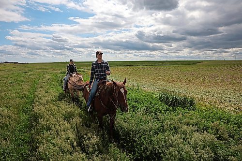 Signe Skaar and Melanie Lund, from Norway, ride horses through a pasture while out for a trail ride with visitors to Lucky Break Ranch southwest of Rivers, Manitoba. Lund and Skaar have been visiting the ranch and helping out for three weeks. (Photos by Tim Smith/The Brandon Sun)