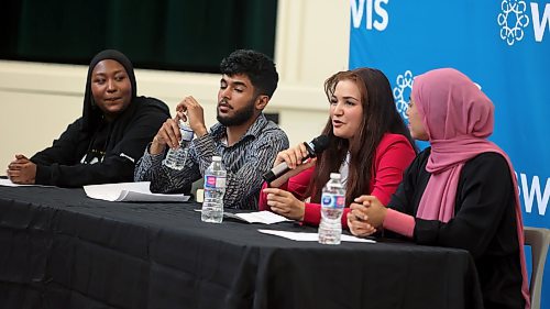 Zainab Mohammed discusses her experience coming from Turkiye to Canada during a youth panel discussion at a World Refugee Day event held by Westman Immigrant Services on Thursday as Amina Ali, and Kaltoum and Jomaa Alabeid look on. (Colin Slark/The Brandon Sun)