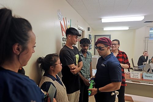 Participants in a forced migration simulation are stopped at a military roadblock during Westman Immigrant Services' World Refugee Day event at its multicultural centre on Thursday. (Colin Slark/The Brandon Sun)