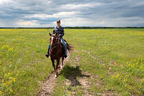 19062024
Melanie Lund, from Norway, rides a quarter horse through a pasture while out for a trail ride with visitors to Lucky Break Ranch southwest of Rivers, Manitoba on Wednesday afternoon. Lund and friend Signe Skaar have been visiting the ranch and helping out for three weeks. (Tim Smith/The Brandon Sun)