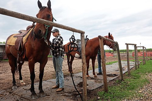 19062024
Signe Skaar, from Norway, takes the saddle off a horse after a trail ride at Lucky Break Ranch southwest of Rivers, Manitoba on Wednesday afternoon. Skaar and friend Melanie Lund have been visiting the ranch and helping out for three weeks. (Tim Smith/The Brandon Sun)