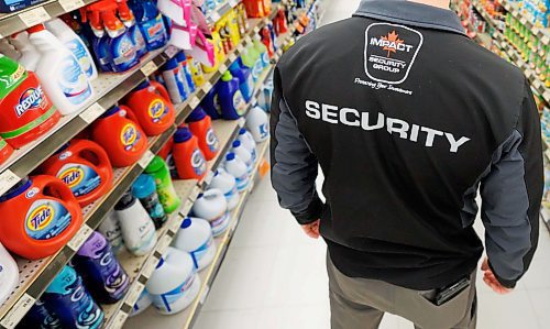 MIKE DEAL / FREE PRESS ILLUSTRATION 
An Impact Security guard walks down a grocery isle.
240531 - Friday, May 31, 2024.