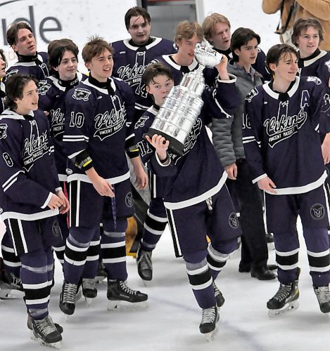 Vincent Massey Vikings coach Brent Blaine looked on from the sidelines as he lets his players celebrate with the Westman High School Hockey League trophy after defeating the Neepawa Tigers in the finals. (Photos by Jules Xavier/The Brandon Sun)