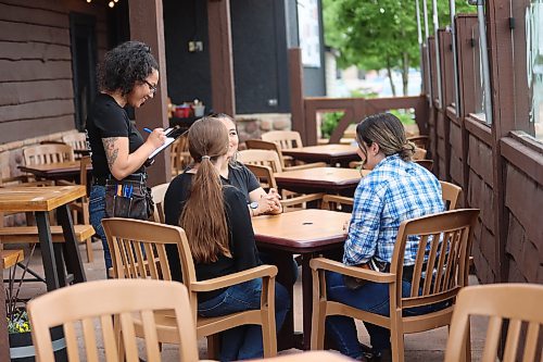 Left: Montana’s BBQ & Bar waiter Karen Carcamo attends to some customers on Friday. (Abiola Odutola/The Brandon Sun)