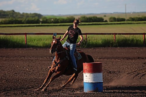 Melanie Lund, from Norway, rounds a barrel atop a horse during the weekly Thursday evening barrel racing and pole bending jackpots at Lucky Break Ranch southwest of Rivers. (Tim Smith/The Brandon Sun)