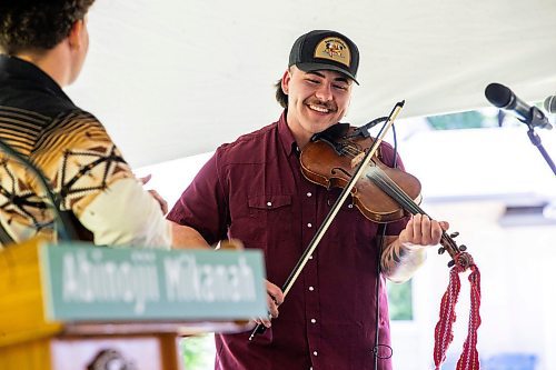 MIKAELA MACKENZIE / FREE PRESS

Luc Wrigley plays the Orange Blossom Special at the Abinojii Mikanah renaming ceremony on Friday, June 21, 2024. 

For Joyanne story.

