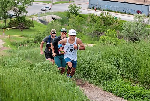 Ruth Bonneville / Free Press

Standup - Mindful Movement 

Photo of Junel Malapad (front) with Jin Lee and Kiernan Underwood, heading up one of the steep sides of Garbage Hill. 

Junel Malapad, an ultramarathon runner and mental health champion.heads a group of runners along the hills  at Westview Park, commonly known as &#x487;arbage Hill&#x4e0;to raise funds for youth mental health services on Friday.  

The run which spanned over 12 hours, from 6 am Friday morning and ends 12 hours later at 6:30pm has participants running a portion of the 12 hours run with funds going to CMHA Manitoba. 

 Junel Malapad,  an ultramarathon runner and mental health champion., has raised over $62,000 over the last ten years  for CMHA Manitoba and Winnipeg and is celebrating his 10th run with hopes of raising $10,000 from supporters from the event.  

June 21st, 2024