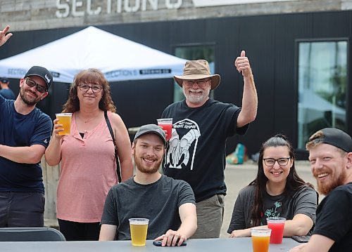 Brandon Schmitz, Angela Berkshire, Eldon Schmitz, (standing), enjoy the day with Mathew Wolf, Rhayna Martens and Nick Martens during Saturday's “Kickin off Summer” downtown Brandon block party, a collaboration between The Dock on Princess, Section 6 Brewing Co., Kickin’ Axe., and Brandon Downtown BIZ. (Michele McDougall/The Brandon Sun)   