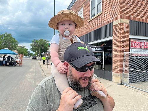 Fourteen-month-old Leo sits on top of his dad Dan Batchelor's shoulders at Saturday's “Kickin' off Summer” downtown Brandon block party, a collaboration between The Dock on Princess, Section 6 Brewing Co., Kickin’ Axe. and Brandon Downtown BIZ. (Photos by Michele McDougall/The Brandon Sun) 