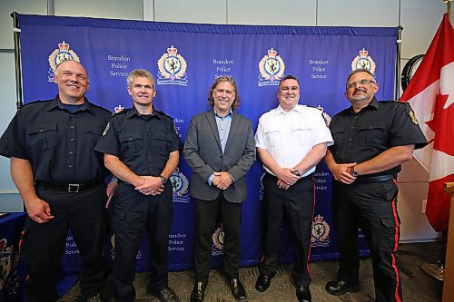 Brandon Mayor Jeff Fawcett (centre) stands with newly promoted officers with the Brandon Police Service, including (from left) Sgt. Trent Karvonen, Sgt. Earl Johnson, Insp. Jason Dupuis and Staff Sgt. Russell Paterson. The promotion ceremony was held on Monday afternoon at Brandon's police headquarters. (Matt Goerzen/The Brandon Sun)