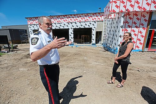 Brandon Police Service acting deputy chief Greg Hebert explains some of changes to BPS headquarters with project manager Stefani Lynch on the construction site of the new detention cell addition along 10th Street on Monday afternoon. (Matt Goerzen/The Brandon Sun)