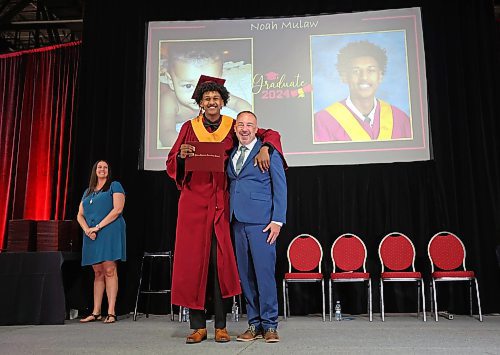 Graduate Noah Mulah throws his arm around principal Bryce Ridgen after receiving his diploma. (Tim Smith/The Brandon Sun)