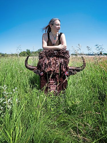 Ruth Bonneville / Free Press

ENT -  Fiber Artist

Story: 49.8 The Creators  

Portrait of Fiber Artist, Maureen Winnicki Lyons in the grassy fields at Living Prairie Museum with her life-like bison head made of  wool, yarn and leather. 

Lyons is a fiber artist who works with wool and yarn. She has collected more than 200 kinds of wool from different breeds of sheep from all over the world although, for reasons of sustainability,  she prefers working with wool from sheep which are bred in Canada. 

She is putting the finishing touches to her life-size wool and yarn bison head which will be suspended from a fence or tree at the Prairie Outdoor Exhibit in this year's Folk Festival
 
See story by AV Kitching 
Writer | Arts & Life | The Free Press

June 24th, 2024