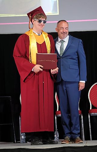 24062024
Graduate Noah Fulford wears sunglasses while posing for photos with Principal Bryce Ridgen after receiving his diploma during Crocus Plains Regional Secondary School&#x2019;s 2024 Convocation at the Keystone Centre on Monday.
(Tim Smith/The Brandon Sun)