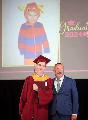 24062024
Graduate Connor Logan poses for photos with Principal Bryce Ridgen under a photo of Logan as a young child after receiving his diploma during Crocus Plains Regional Secondary School&#x2019;s 2024 Convocation at the Keystone Centre on Monday.
(Tim Smith/The Brandon Sun)
