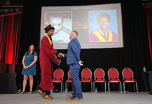 24062024
Graduate Noah Mulah shakes the hand of Principal Bryce Ridgen after receiving his diploma during Crocus Plains Regional Secondary School&#x2019;s 2024 Convocation at the Keystone Centre on Monday.
(Tim Smith/The Brandon Sun)