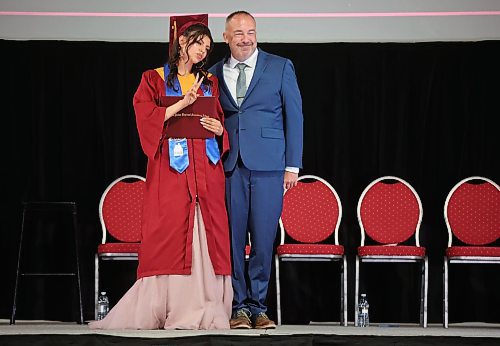 24062024
Graduate Mercedes Demas flashes a peace sign while  posing for photos with Principal Bryce Ridgen after receiving her diploma during Crocus Plains Regional Secondary School&#x2019;s 2024 Convocation at the Keystone Centre on Monday.
(Tim Smith/The Brandon Sun)