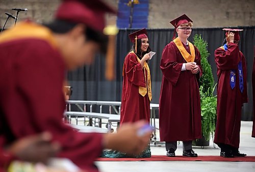 24062024
Graduates fan theirselves as they wait to be called up to accept their diploma during Crocus Plains Regional Secondary School&#x2019;s 2024 Convocation at the Keystone Centre on Monday.
(Tim Smith/The Brandon Sun)