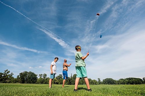 Ruth Bonneville / Free Press

Standup - Flying kites

T'ai Pu and his sons Satya and Akili Mapu enjoying a day at the beach

Dad, T'ai Pu  takes advantage of the windy day to have some fun with his two sons flying kites in the field at Assiniboine Park Monday.  Their duo line, parafoil stunt kites kept them very busy as they whipped around in the wind gusts of up to 4kKM/H.  

Names:
T'ai Pu - dad
Satya Mapu -9yrs (green shirt) 
Akili Tapu 10yrs  (white shirt)

June 24tth, 2024