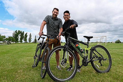 Matt Frank / Free Press
Luke Barr (left), a guidance counselor at &#xc9;cole Stanley Knowles School and Max Bundoc (right), a Grade 8 student, stand with their bikes on the grounds of the newly announced Fairgrove Park Community Trail on Tuesday, June 25. 
240625 - Tuesday, June 25, 2024.