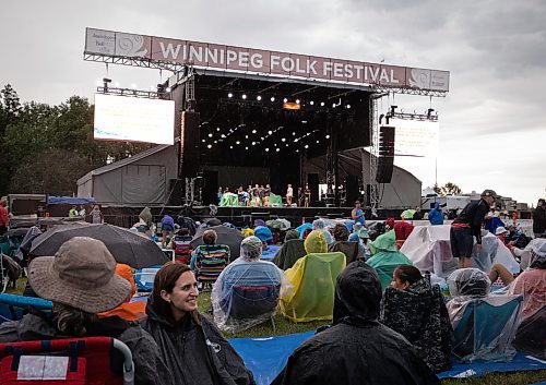 JESSICA LEE / WINNIPEG FREE PRESS

Alexia Rescue-Naurocki (in black) is photographed July 6, 2023 at Folk Fest during a break when the festival stopped due to weather concerns.

Reporter: Eva Wasney