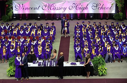 Graduates receive their diplomas during Vincent Massey High School’s 2024 convocation at the Keystone Centre on Tuesday. (Tim Smith/The Brandon Sun)