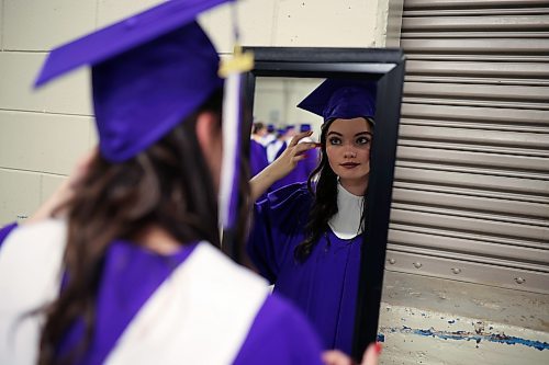 Graduate Summer Sheppard-Jackson checks her hair in a mirror prior to the ceremony. (Tim Smith/The Brandon Sun)