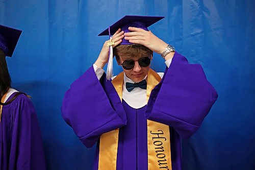 25062024
Graduate Yurii Stasyk adjusts his mortarboard prior to Vincent Massey High School&#x2019;s 2024 Convocation at the Keystone Centre on Tuesday.
(Tim Smith/The Brandon Sun)