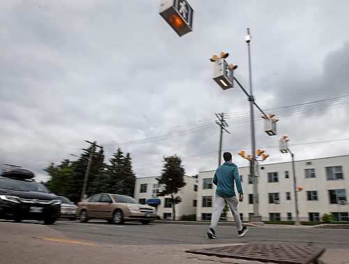 JOHN WOODS / FREE PRESS
People use a new crosswalk at St Mary and Carrier Monday, June 24, 2024. The city has added lights and time at several crosswalks.

Reporter: joyanne