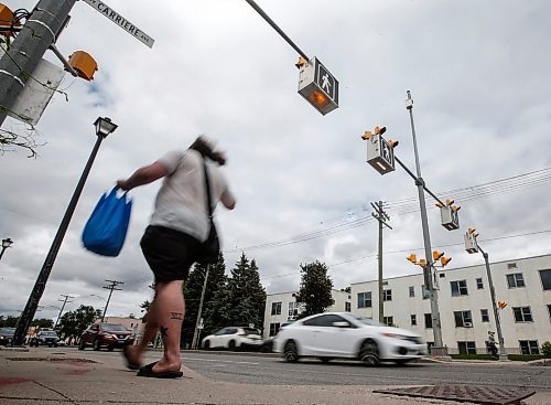 JOHN WOODS / FREE PRESS
People use a new crosswalk at St Mary and Carrier Monday, June 24, 2024. The city has added lights and time at several crosswalks.

Reporter: joyanne