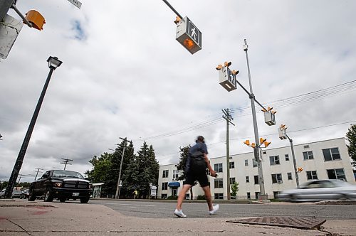 JOHN WOODS / FREE PRESS
People use a new crosswalk at St Mary and Carrier Monday, June 24, 2024. The city has added lights and time at several crosswalks.

Reporter: joyanne